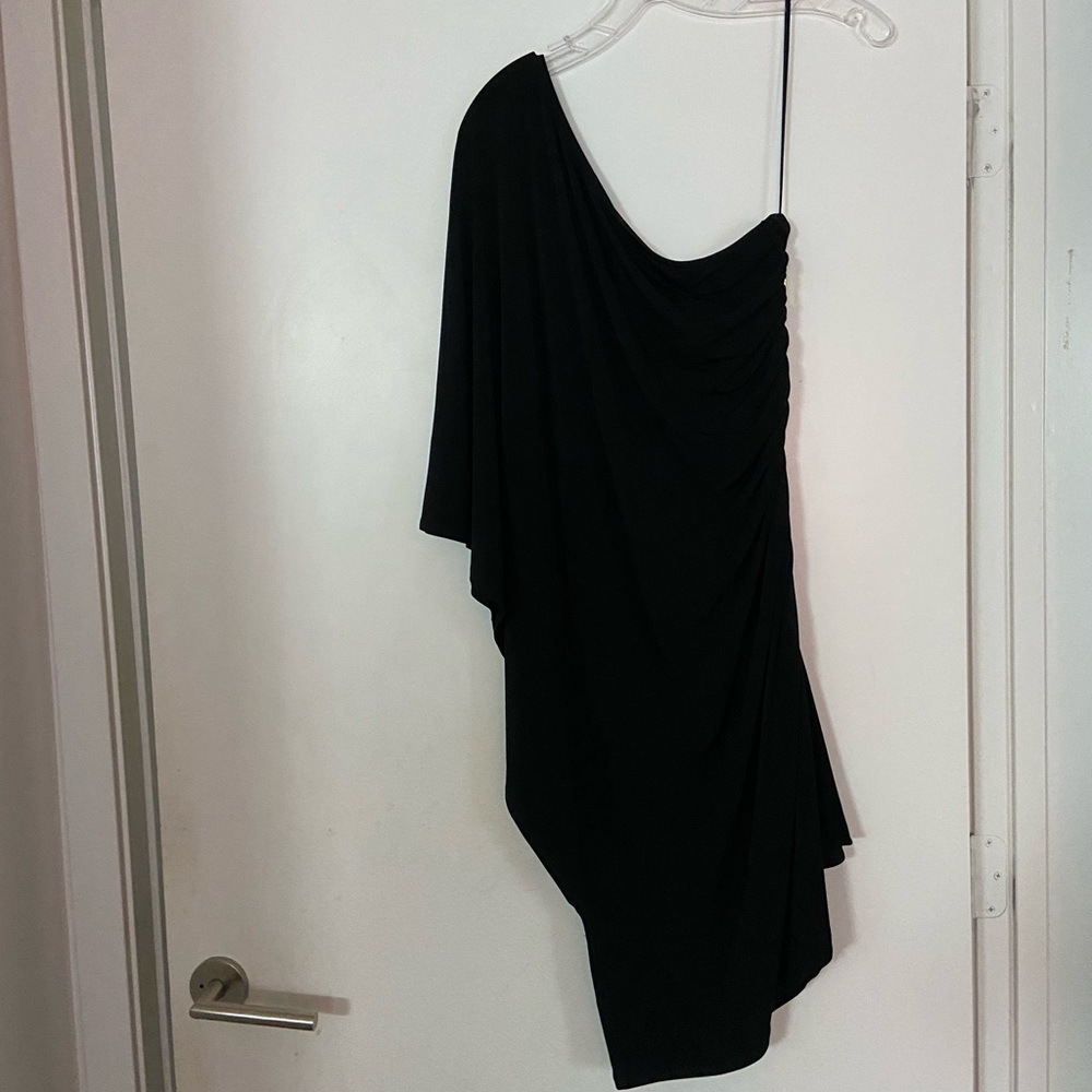 One sleeve bat style black dress with a golden zipper on the strapless side